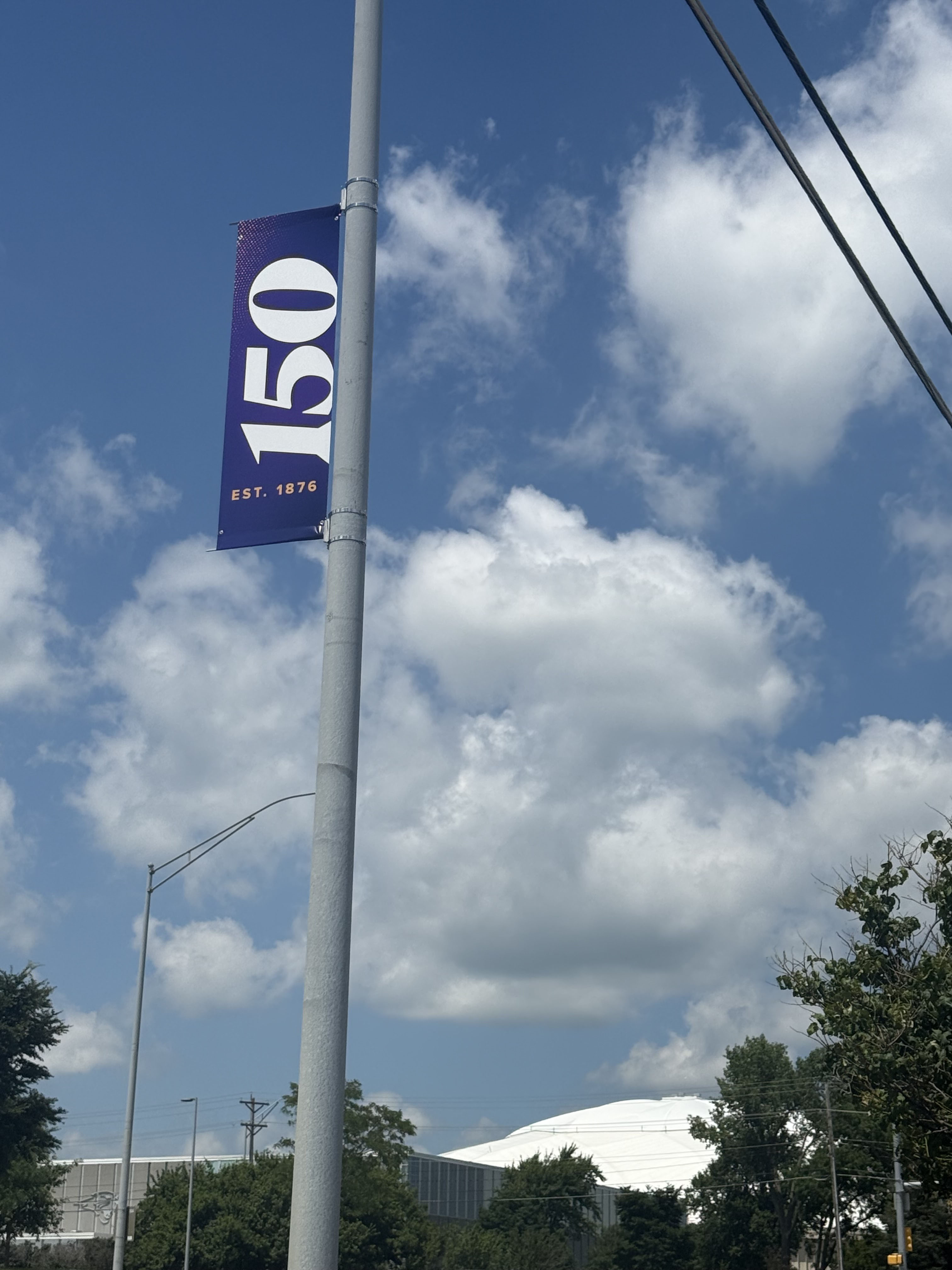 Purple 150 light-pole banner overlooking UNI-Dome