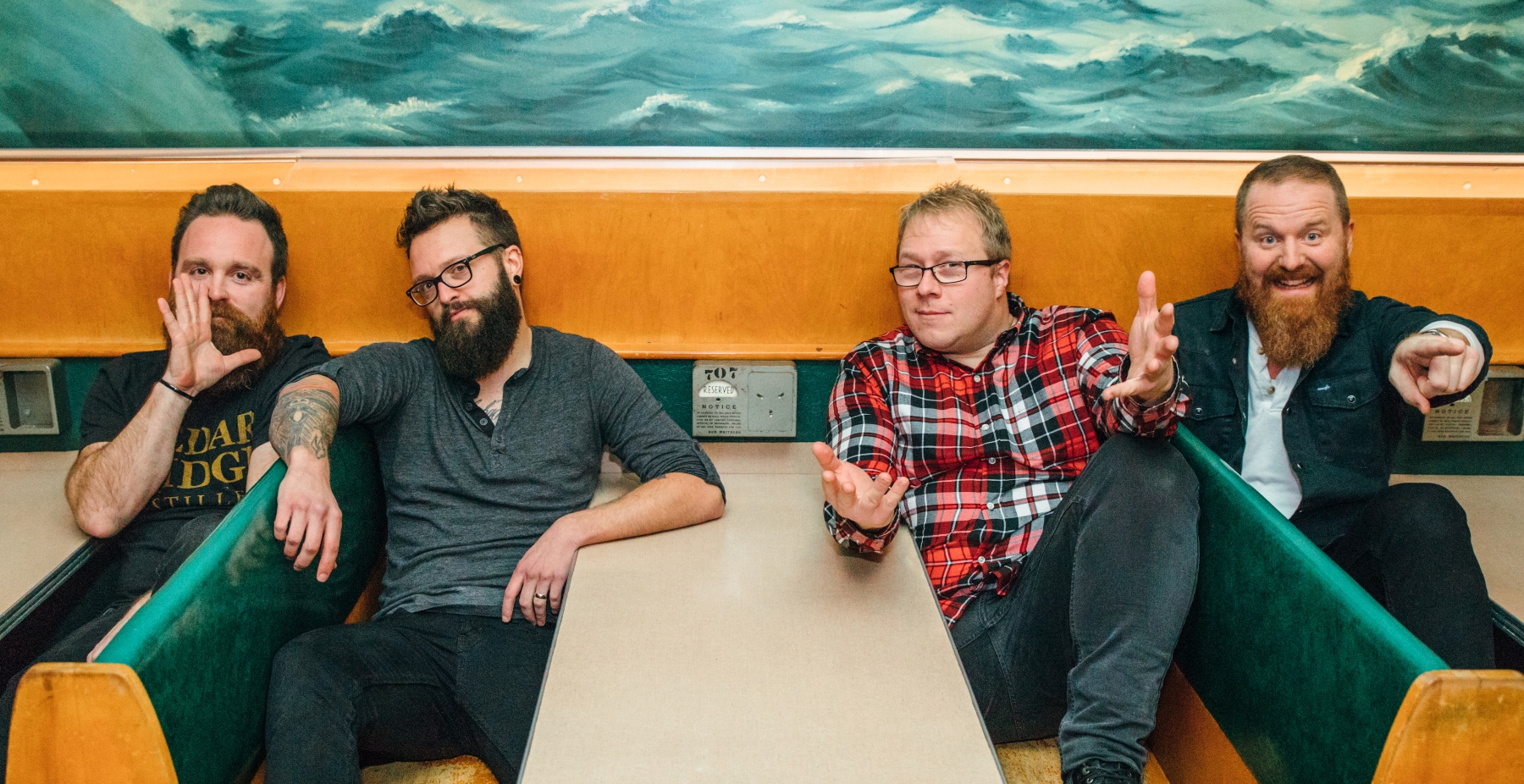 Members of the Pork Tornadoes sitting in booth at a restaurant