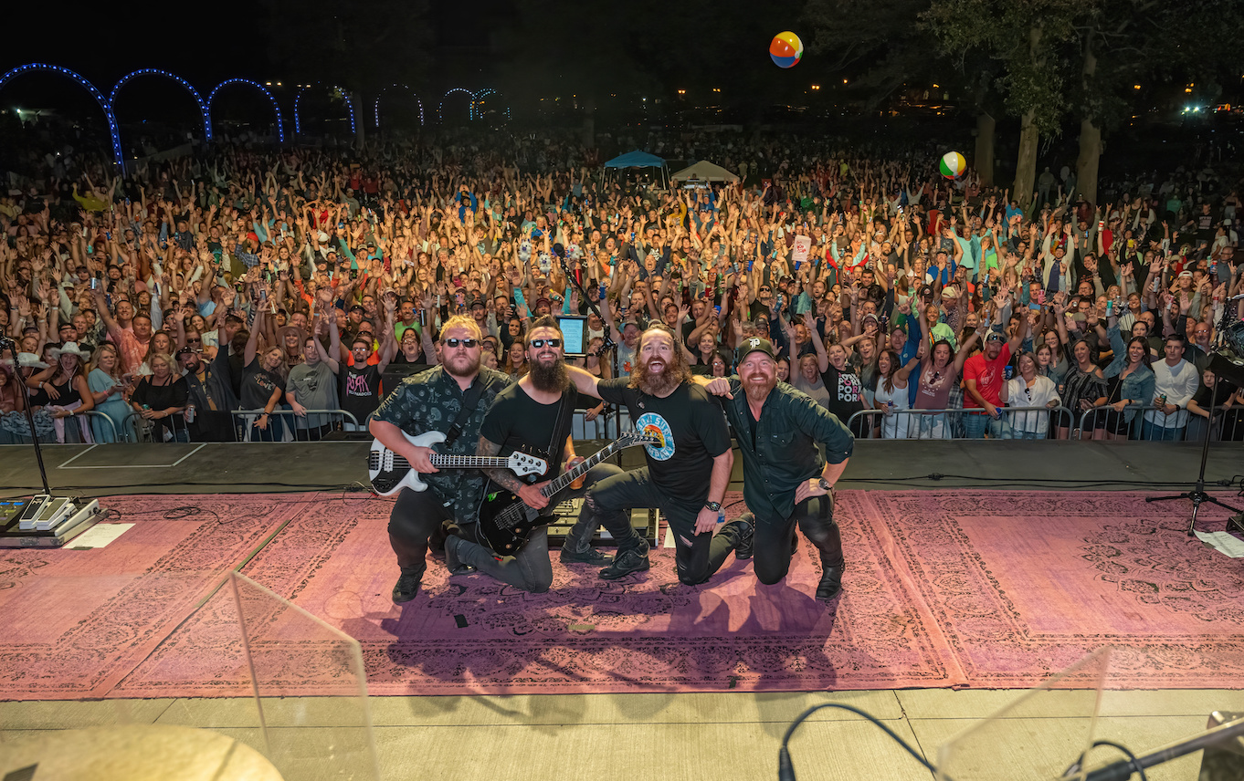 The Pork Tornadoes posing on stage in front of a crowd