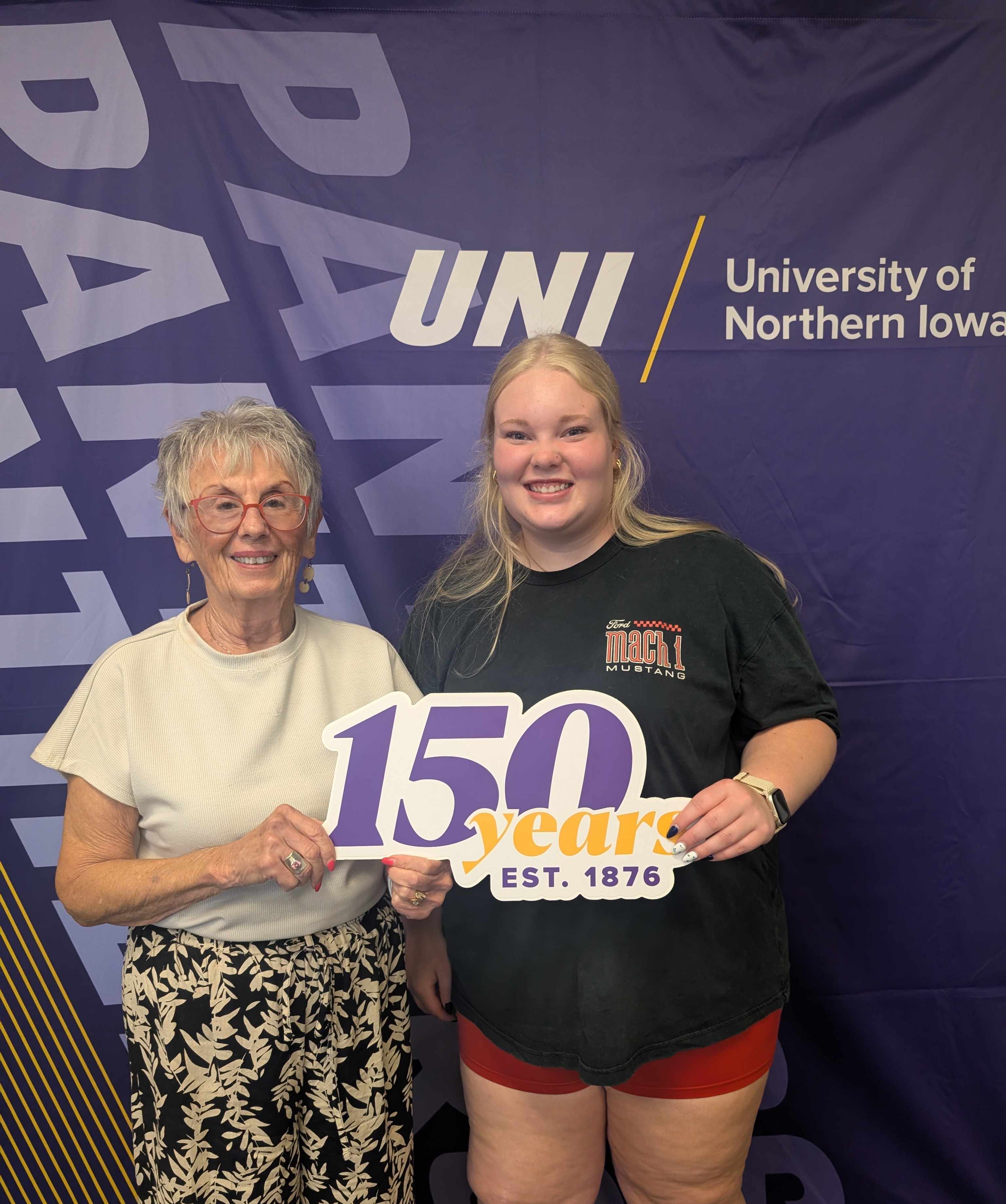 Sally and Ava McGreevy holding 150 years sign