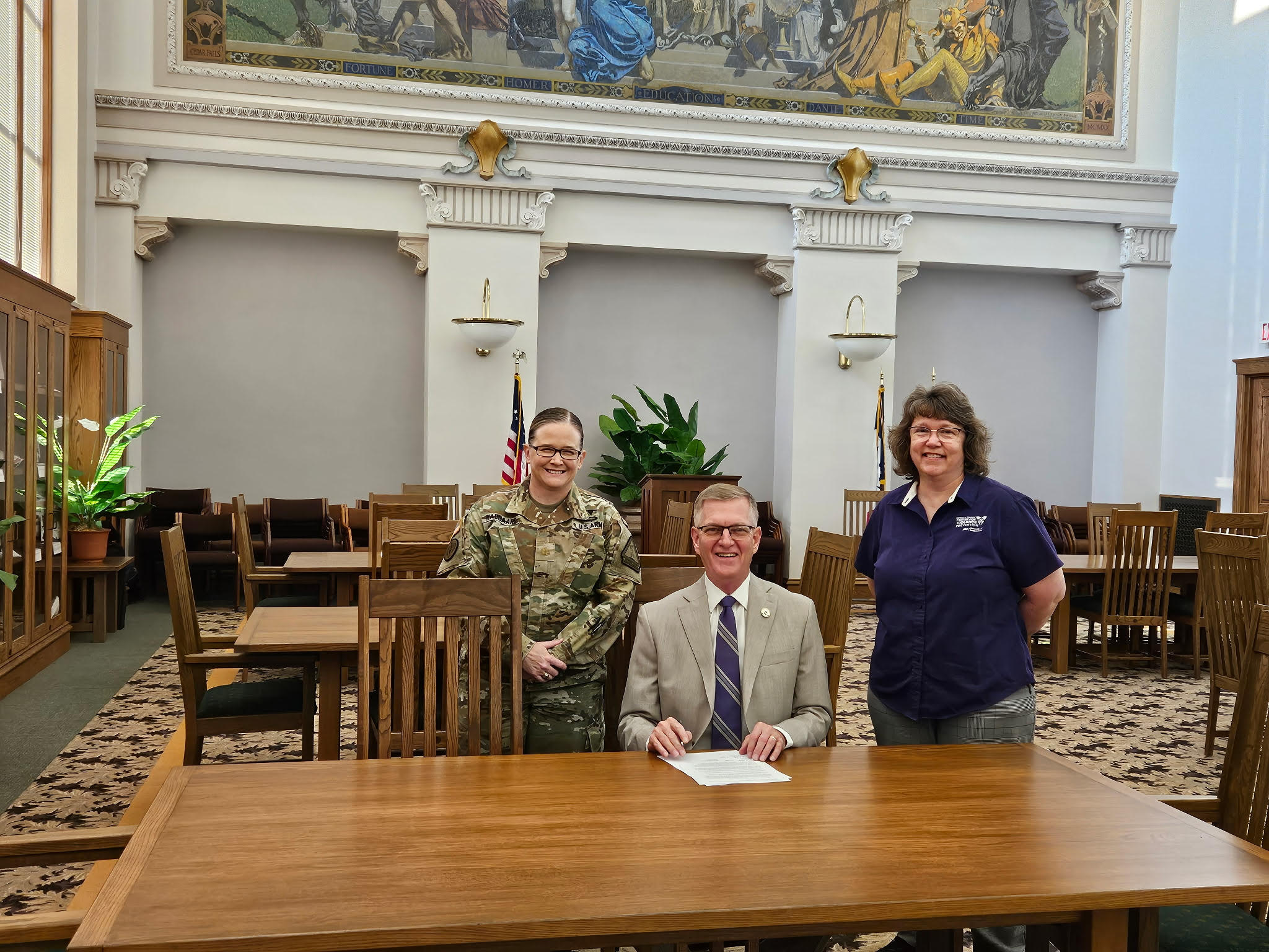 President Nook, Major Jess Haugaard of the Iowa National Guard, and Dean Brenda Bass with memorandum of understanding