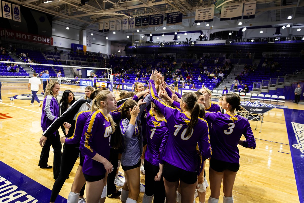 The Panther volleyball team huddles on the floor at Drake