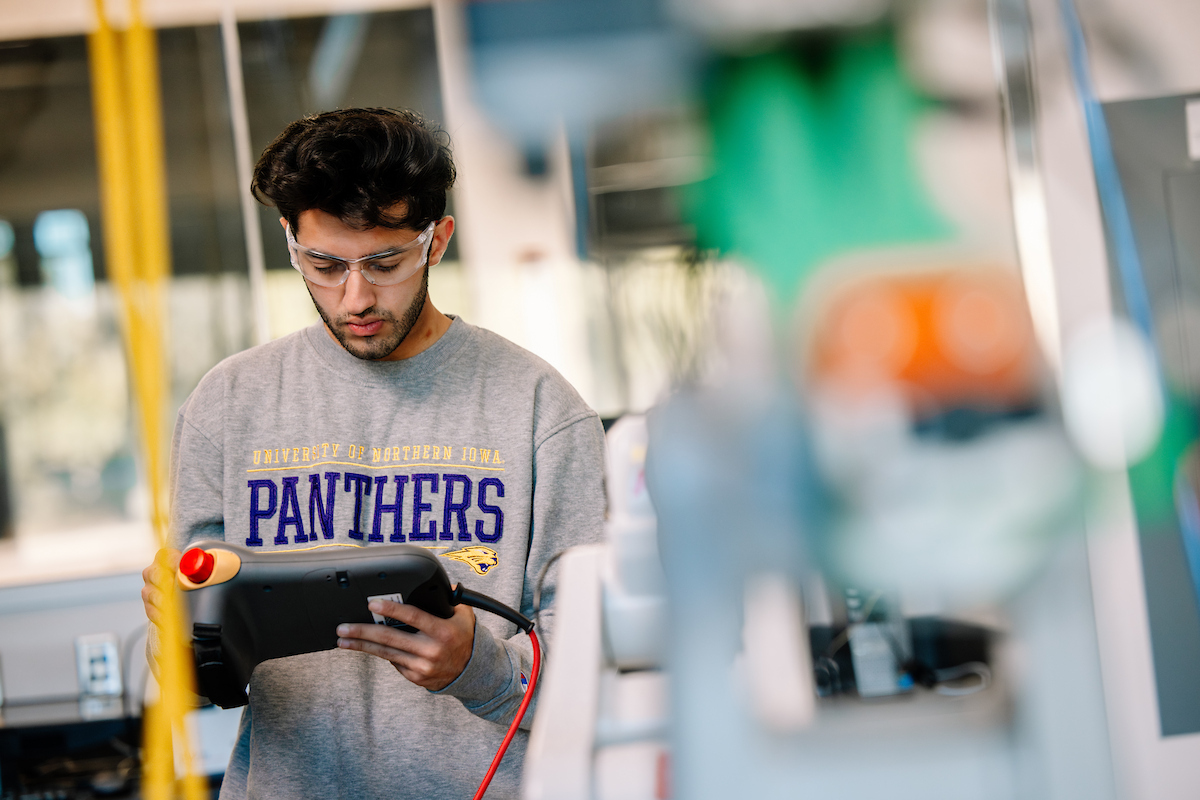 Student operating robot in the Applied Engineering Building