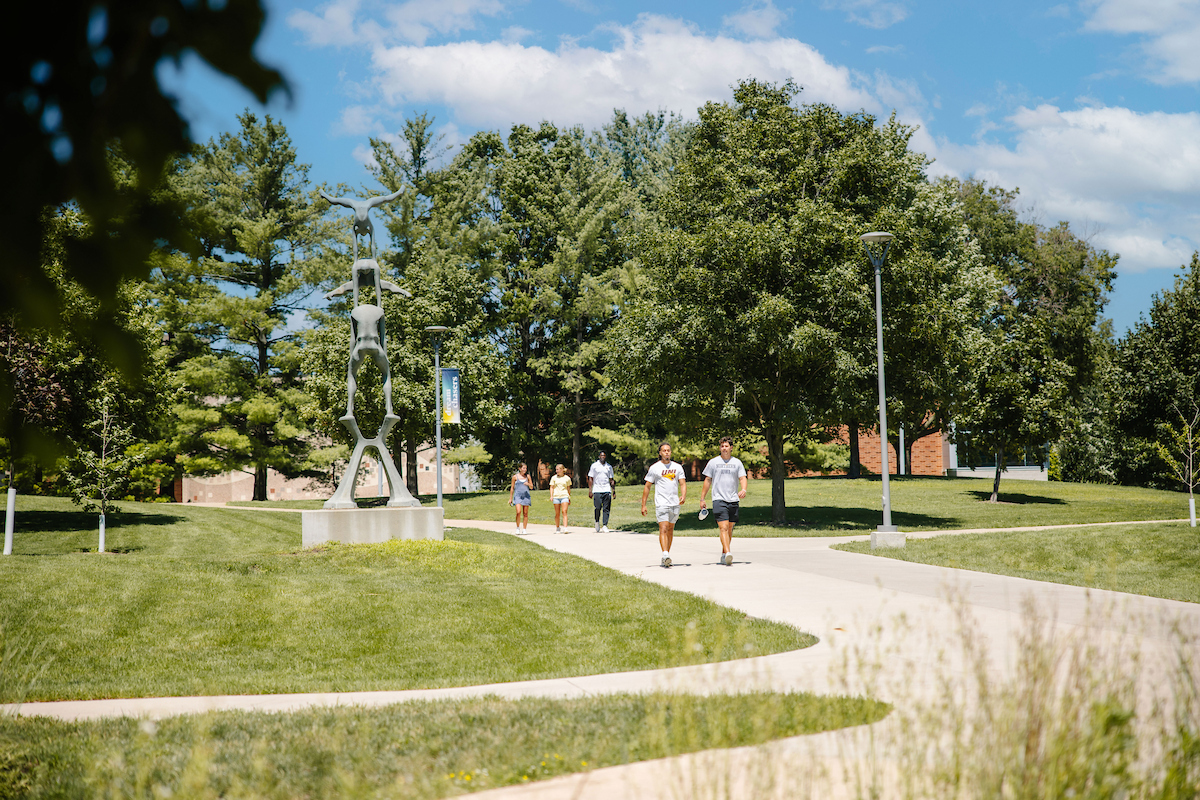 Students walking on UNI campus in the summer
