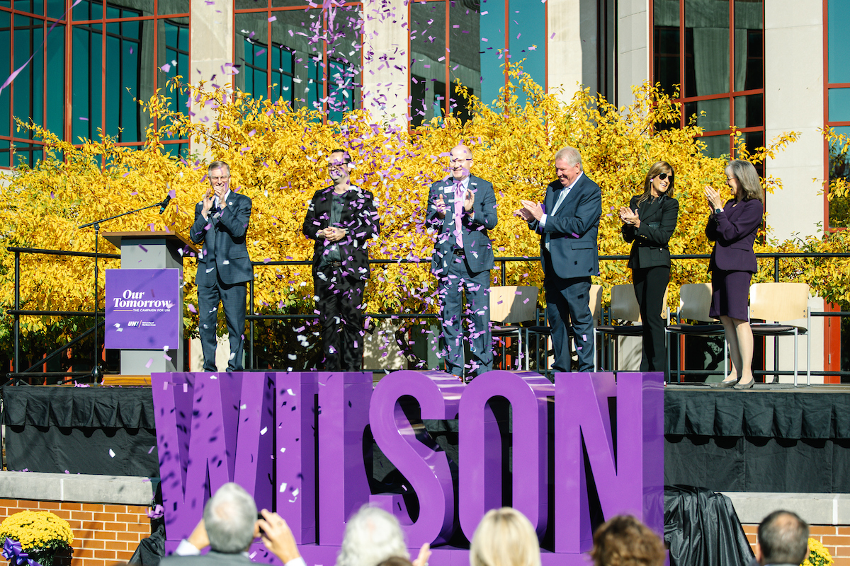 Confetti explodes around Wilson signage at announcement of $25 million donation