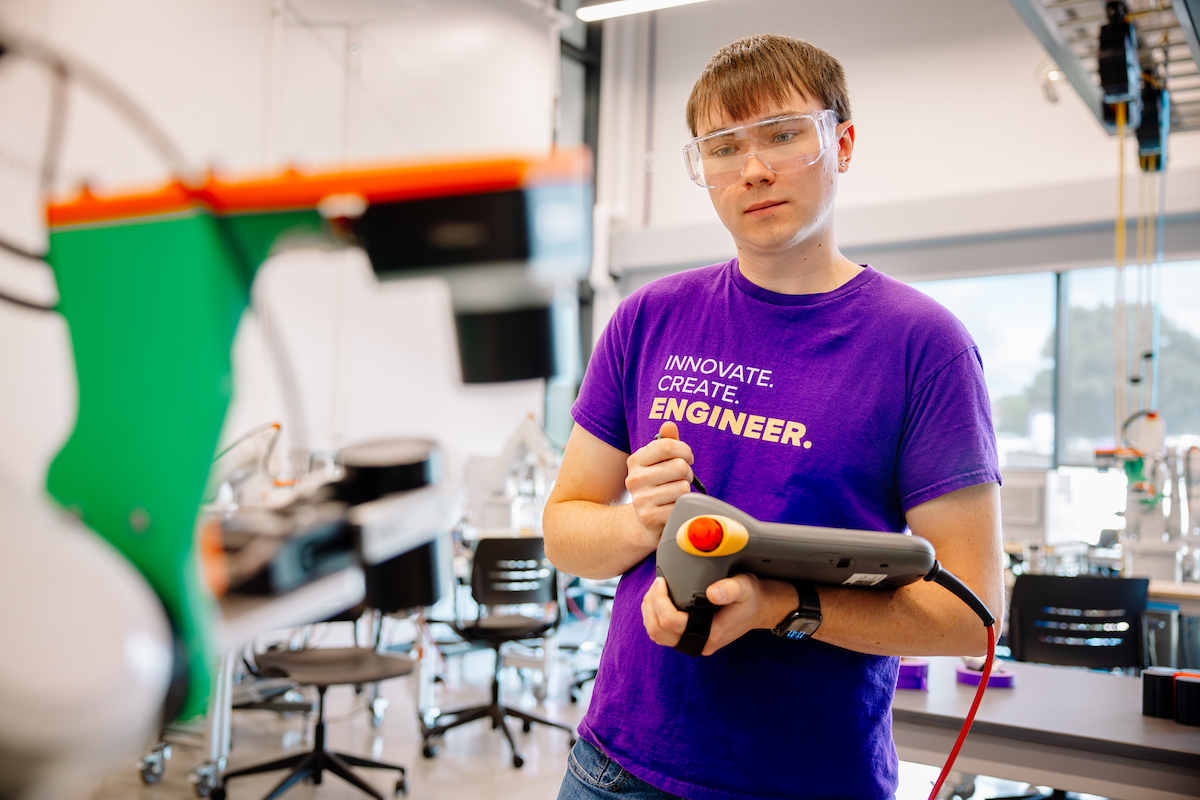 Elijah Yates operating robot in Applied Engineering Building