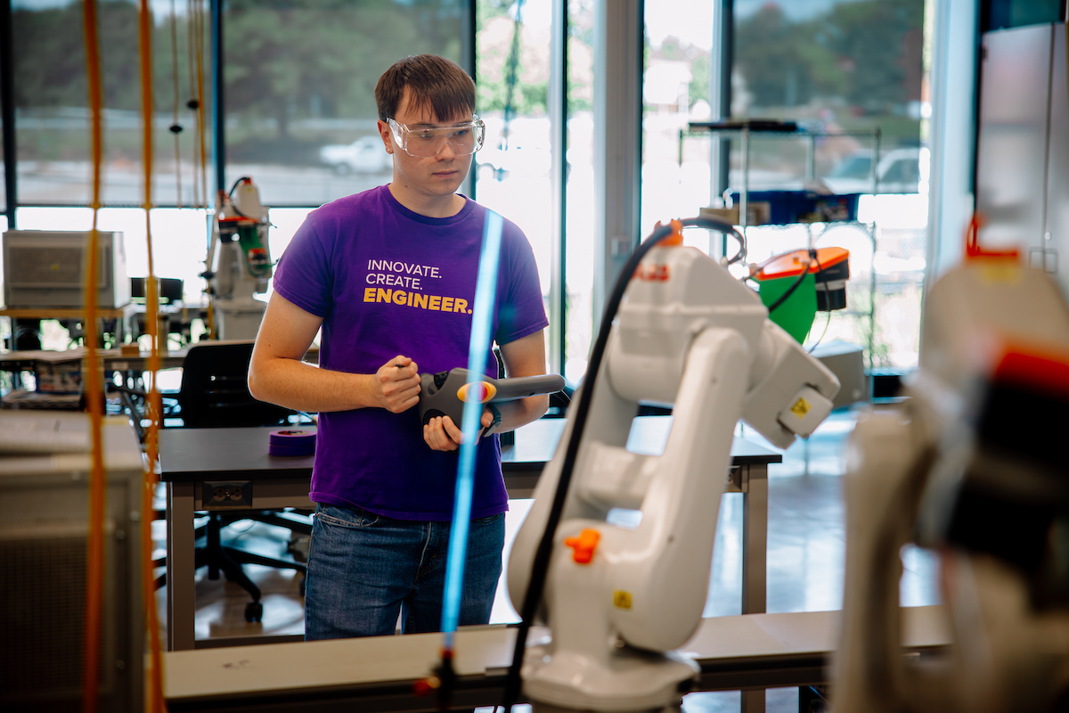 Elijah Yates operating robot in Applied Engineering Building
