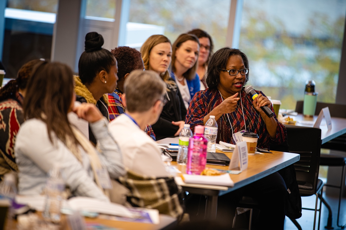 Audience member asks question at System of Support Conference