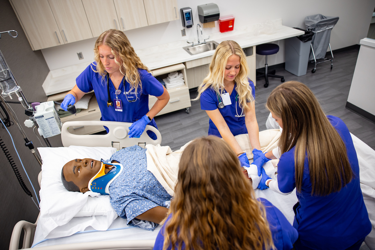 Nursing students working on medical manikin