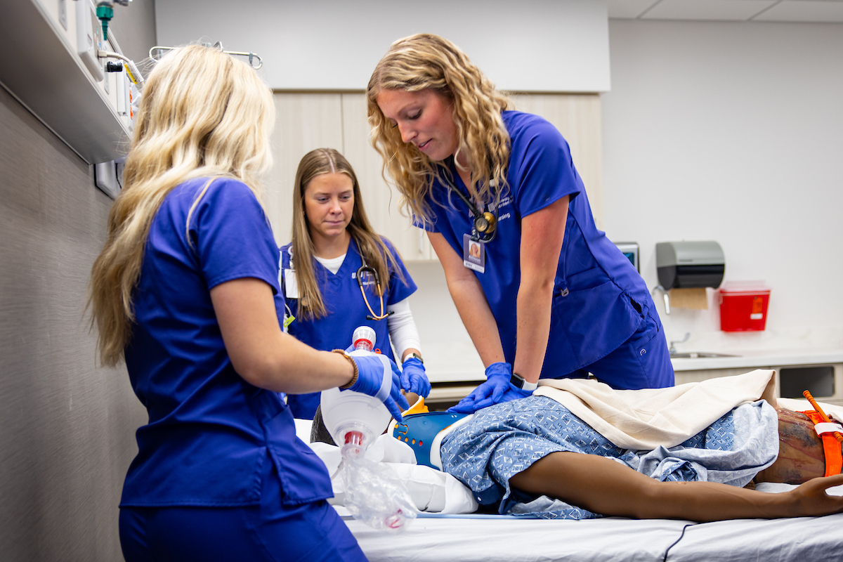 Nursing students provide care for medical manikin