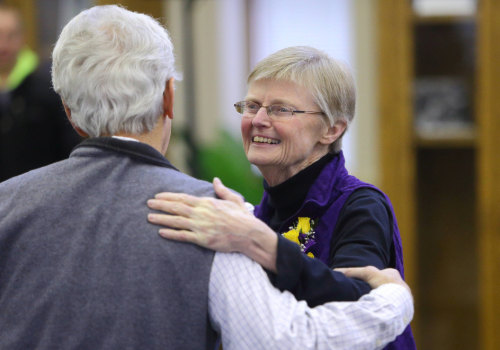 Geadelmann greeting a visitor at her retirement celebration in 2015.
