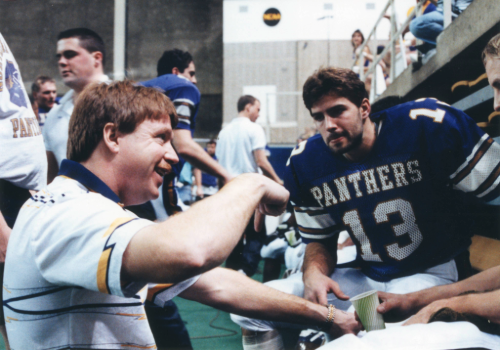 Coach Allen talking to Kurt Warner. 