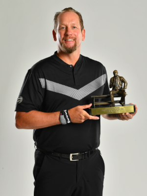 Photo of Nick Nurse holding his Coach of the Year award.