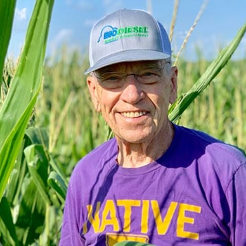 Grassley in field with Iowa Native shirt on.