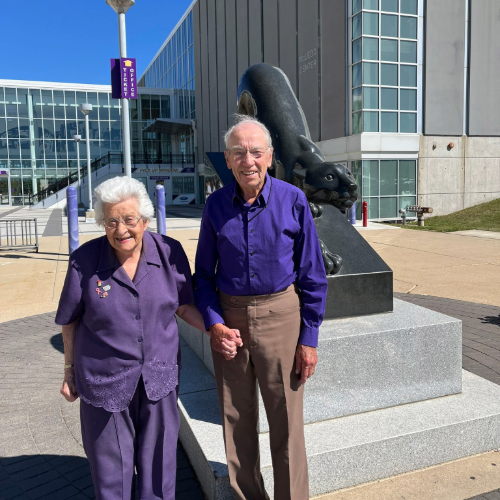 Grassley and wife attending UNI football game.
