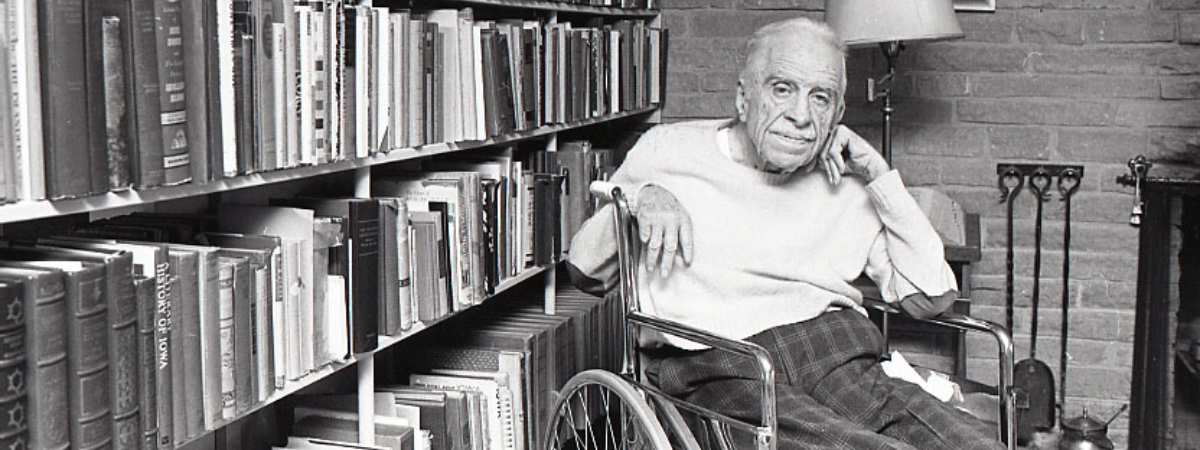 James Hearst in front of bookcase.