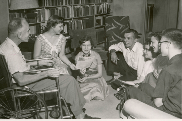 James Hearst sitting with students in his home.