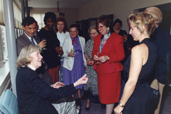 Mona Van Duyn talking with group of people.