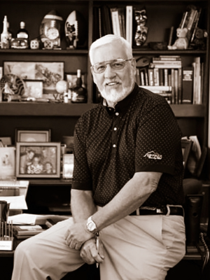 Miller sitting on his desk. 