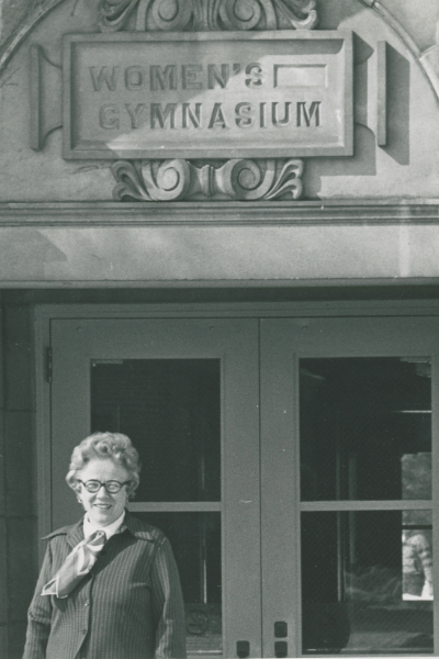 Elinor Crawford standing in front of the Women's Gymnasium.