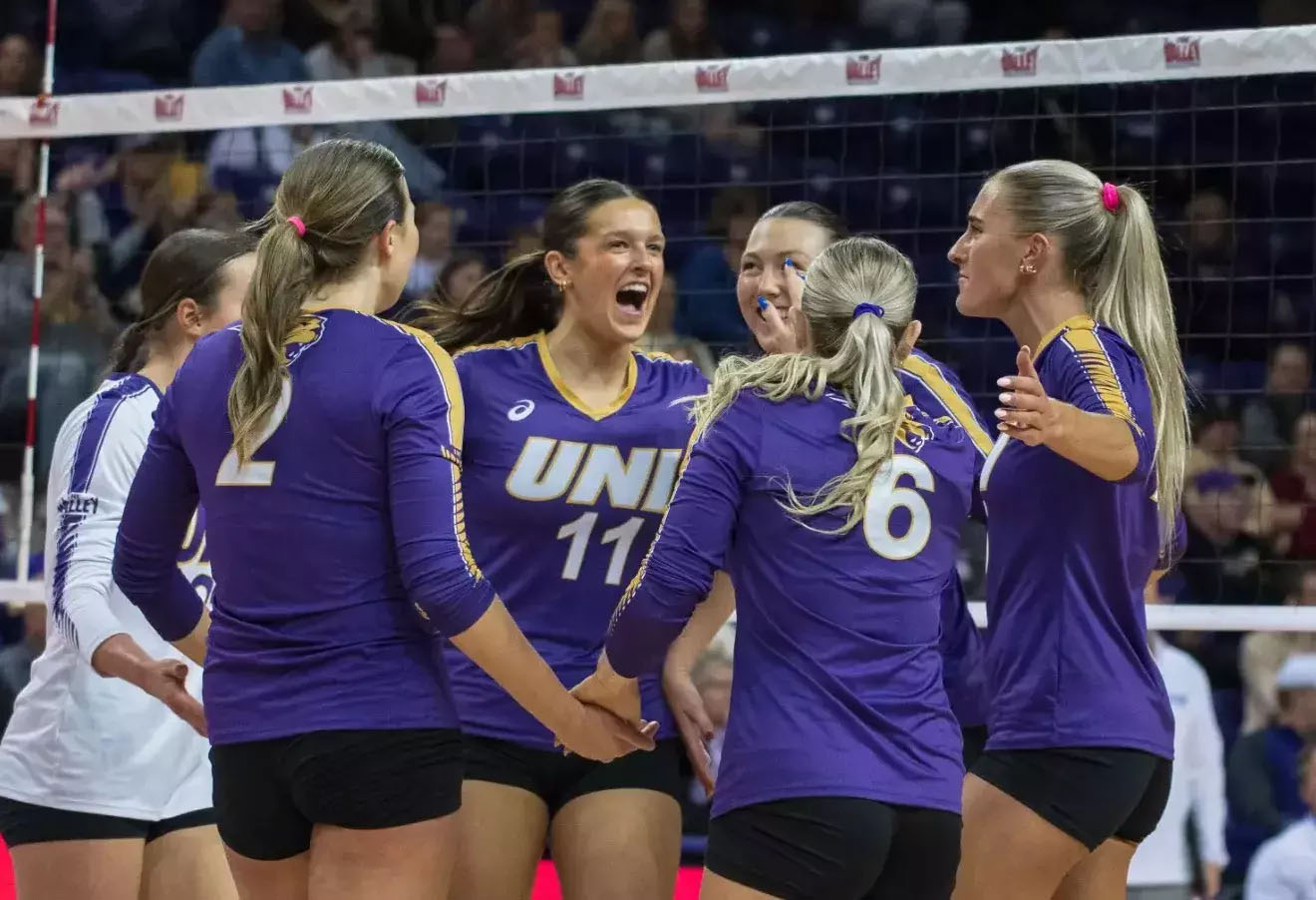 UNI volleyball players celebrate win