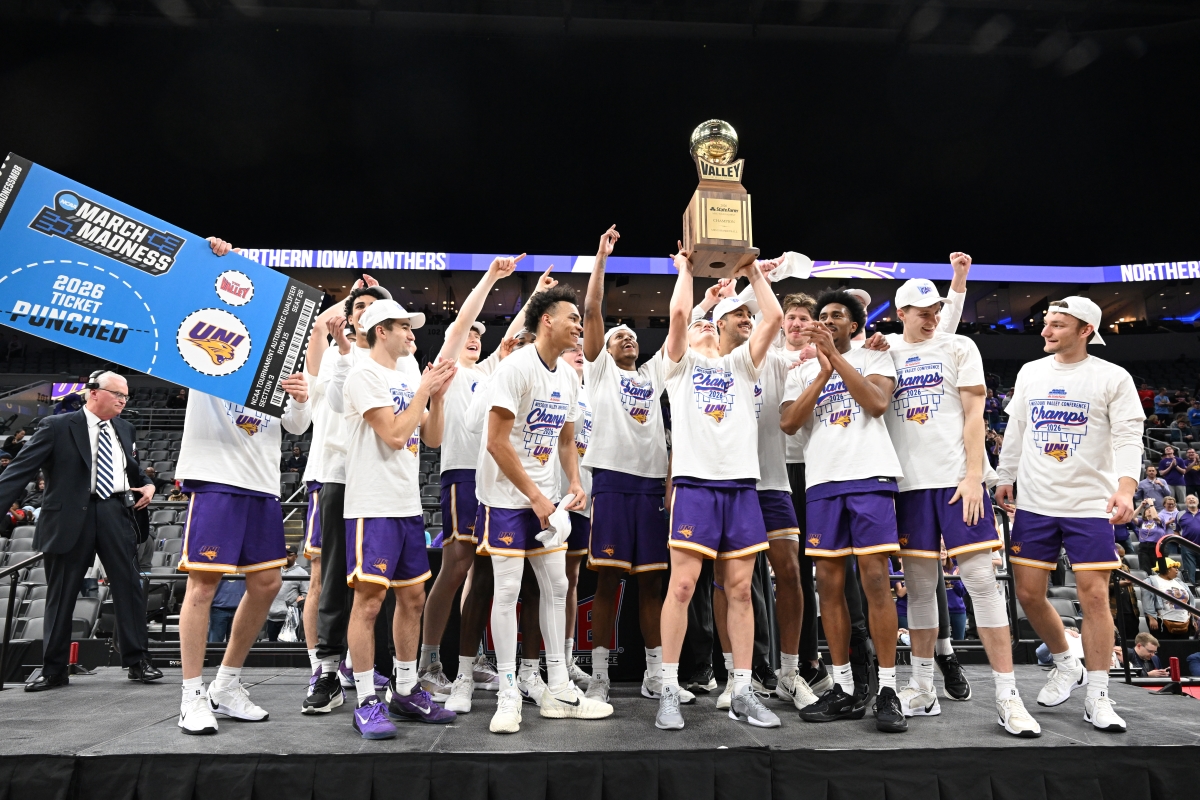 Panther men's basketball team lifting Arch Madness trophy