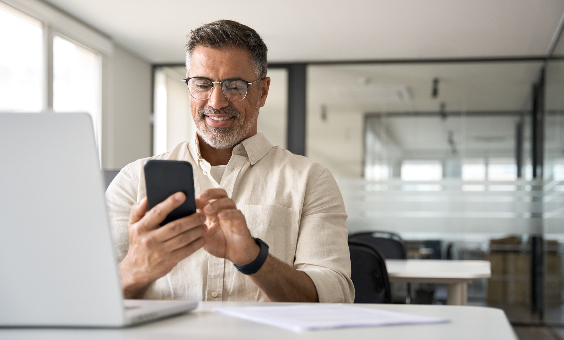 Middle-aged man looking at smartphone