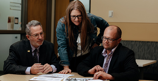 Drew Conrad, Kim Eastman and Dan Beenken working on a project