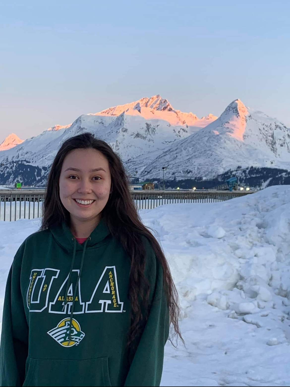 Dezirae Wiley in Alaska in front of snow-covered mountains