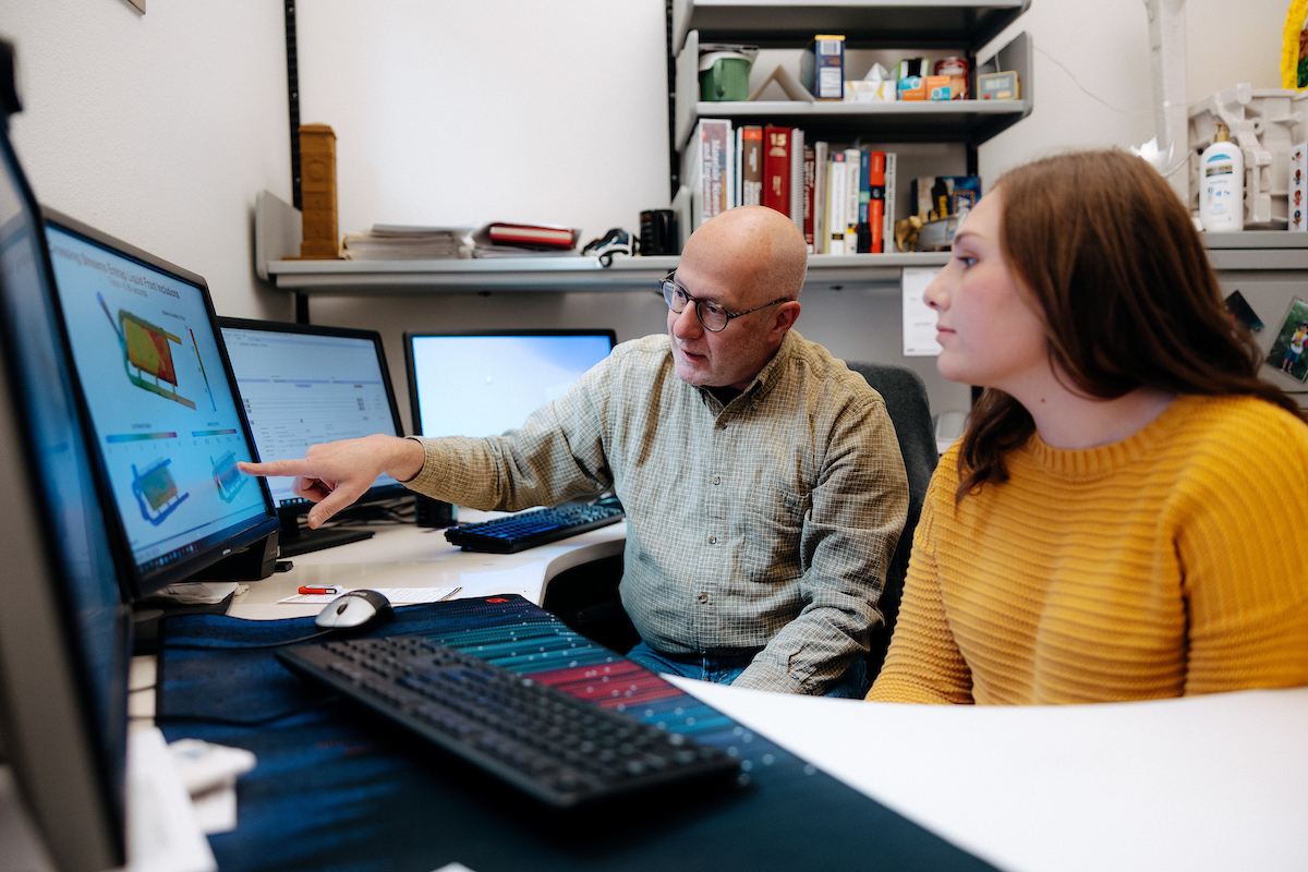 Professor working with engineering student