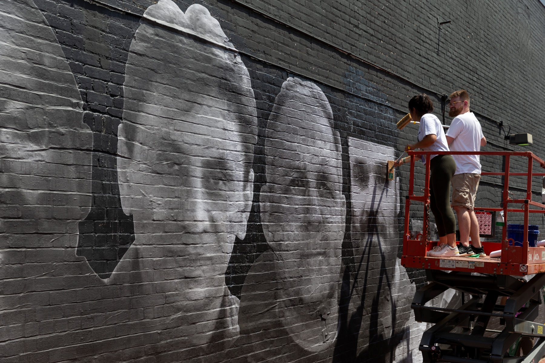 Isaac Campbell works on mural featuring Paul Whelan