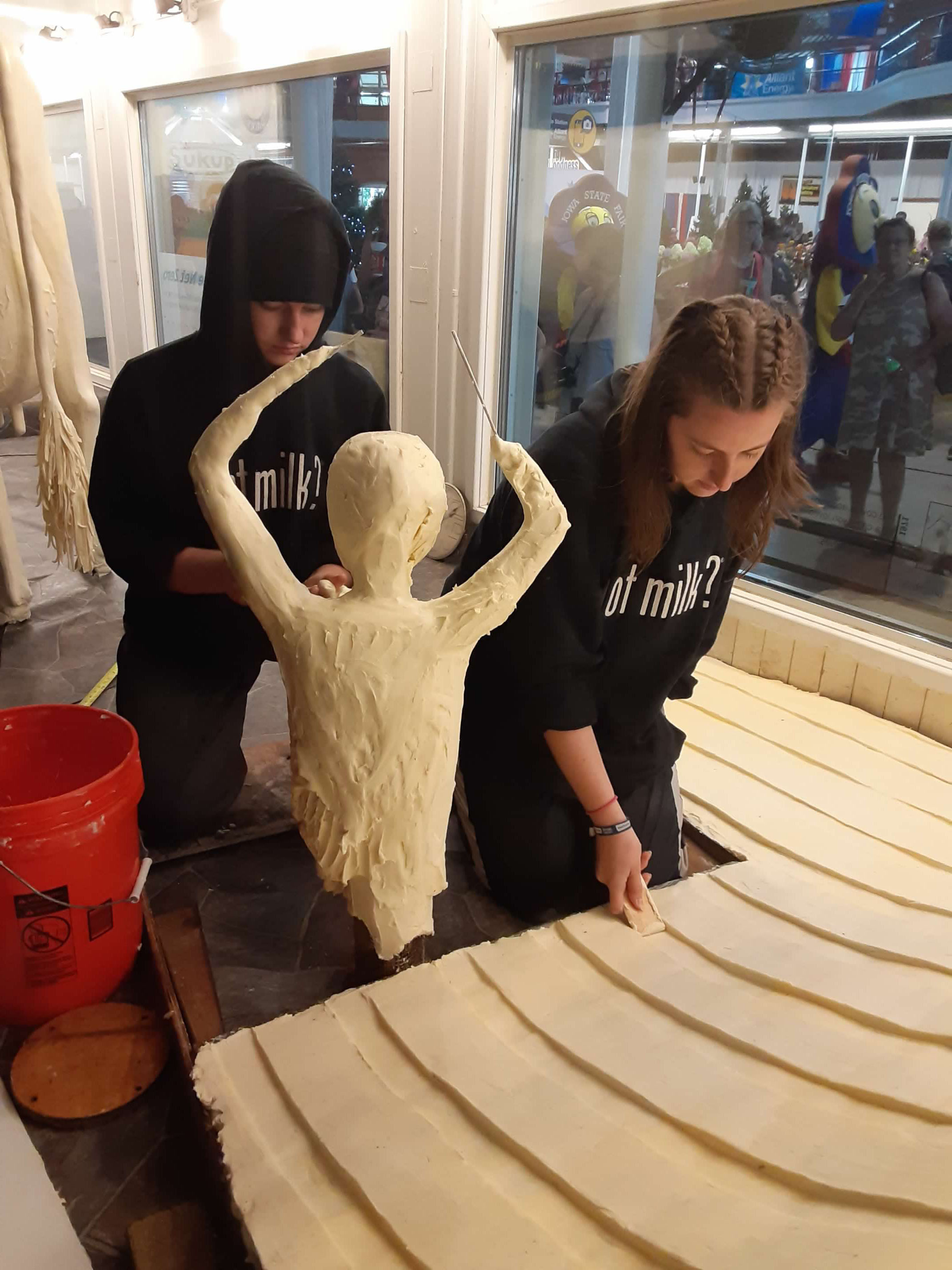 Hannah and Grace Pratt sculpting slide out of butter