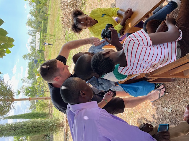 Brett Meehan showing Kenyan children a camera