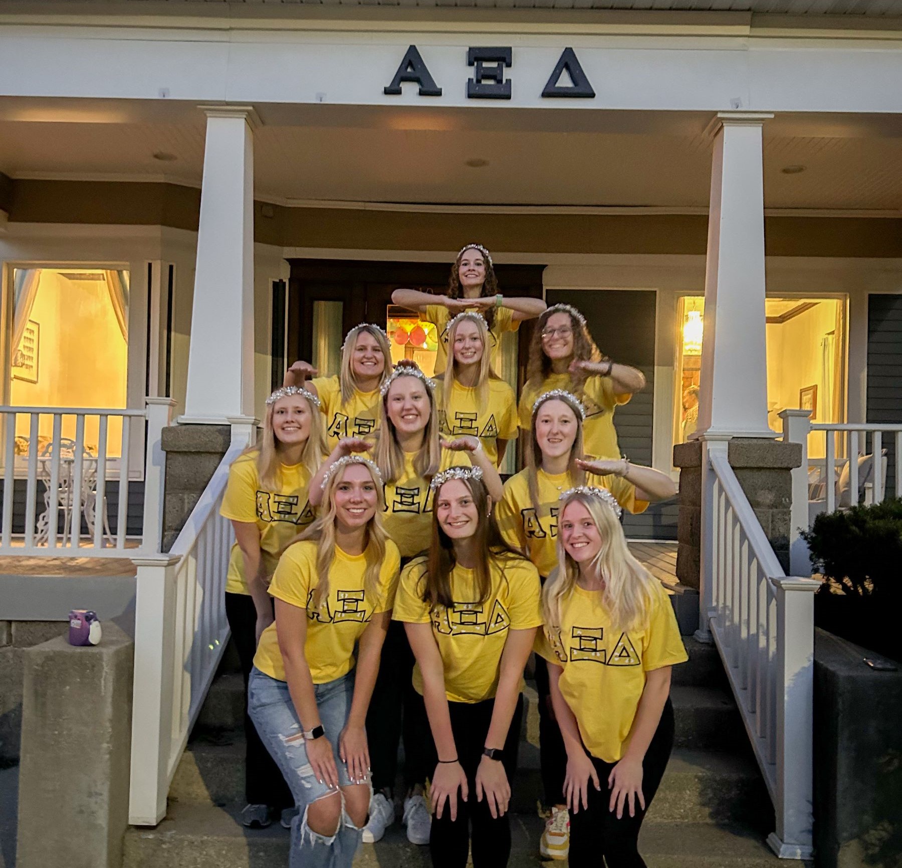 Kate Rogers with sorority sisters in front of sorority house