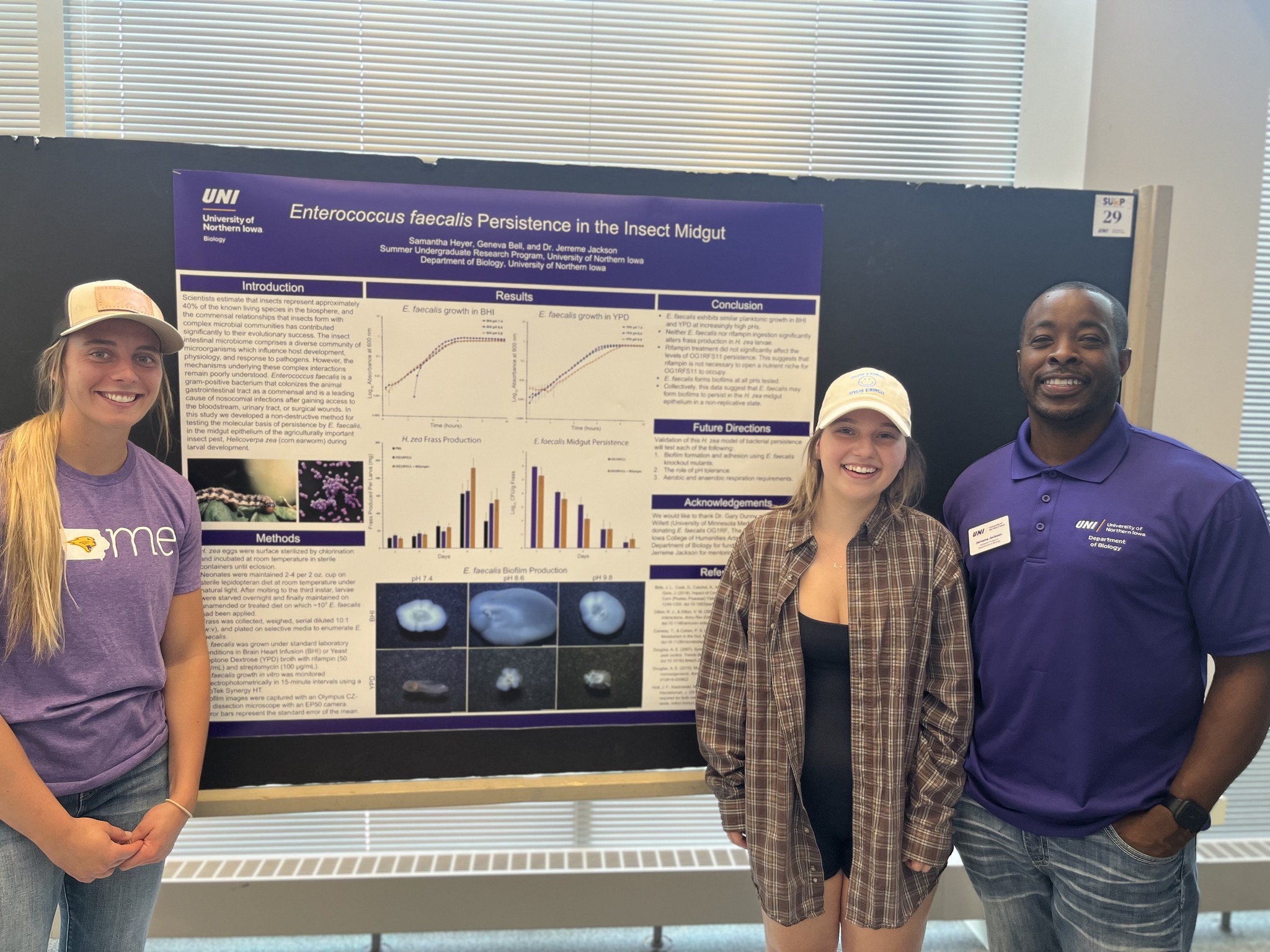 Samantha Heyer, Geneva Bell and Jerreme Jackson standing in front of their research poster
