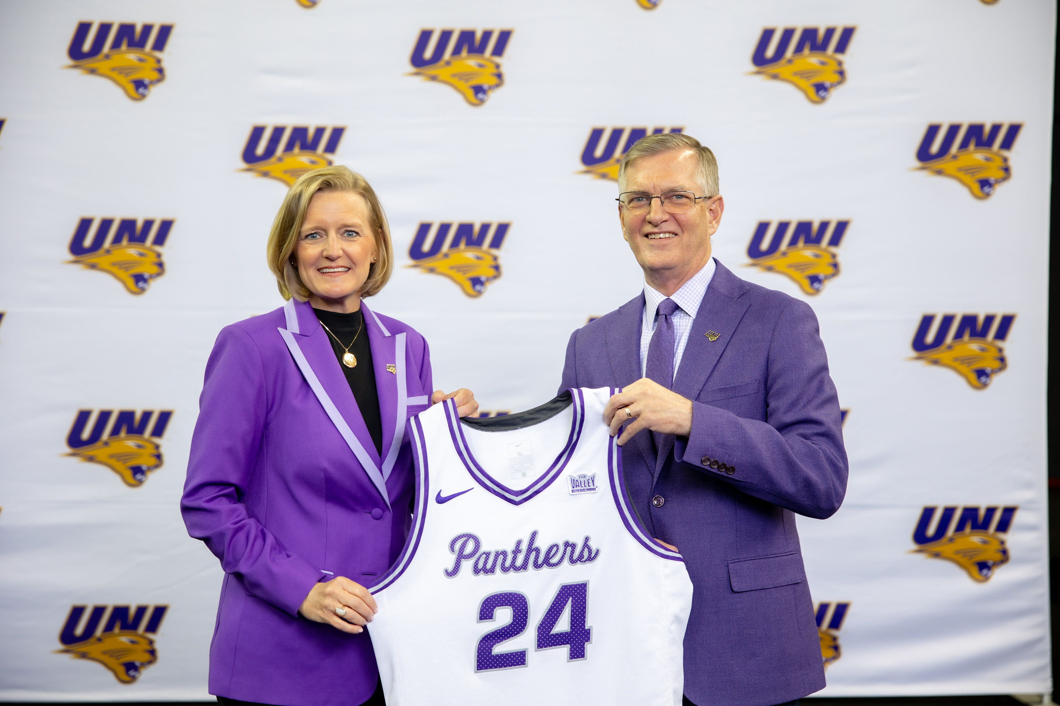 President Nook gifting Megan Franklin with Panther jersey