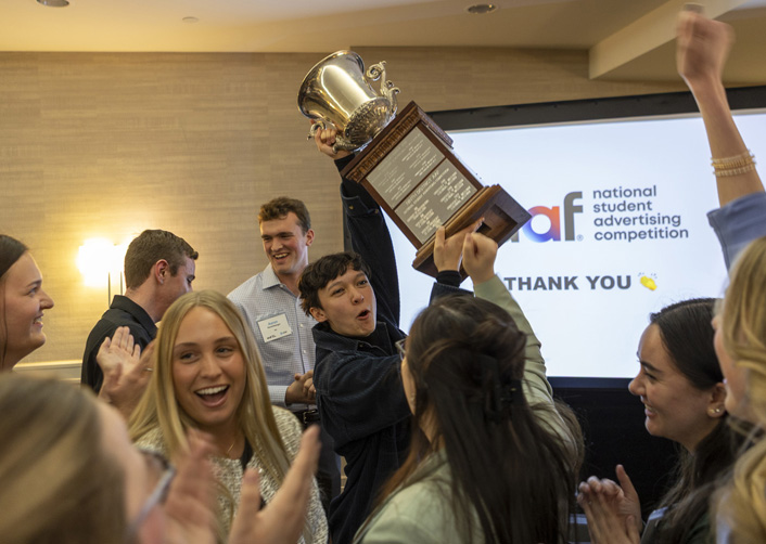 Students cheer and raise trophy at NSAC