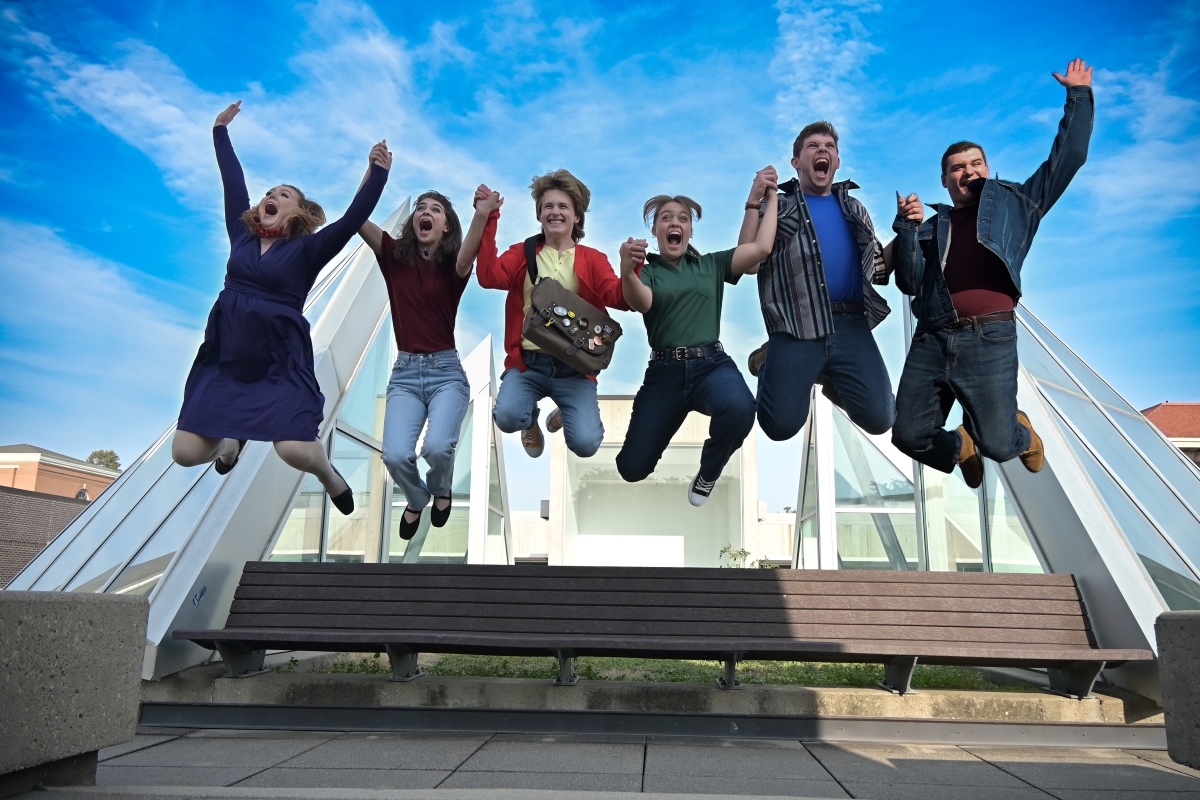 Cast of Ordinary Days jumping in the air