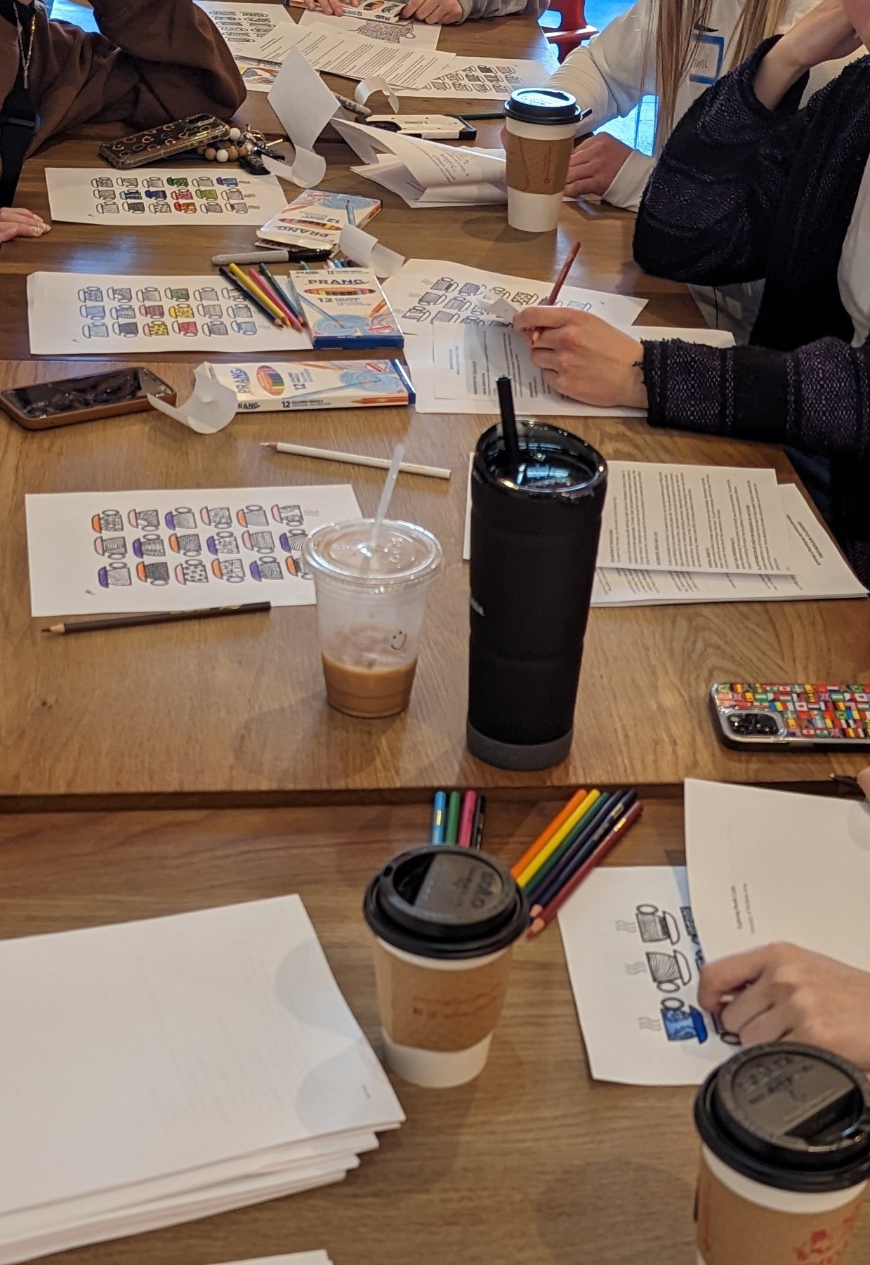 Death cafe participants coloring at a table