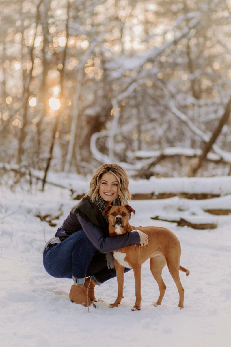 Riley Schreder and her dog outside in the snow