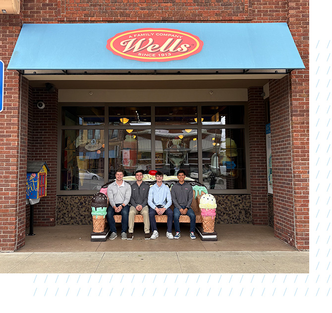 Mitchell Augustine sits outside well with his fellow interns