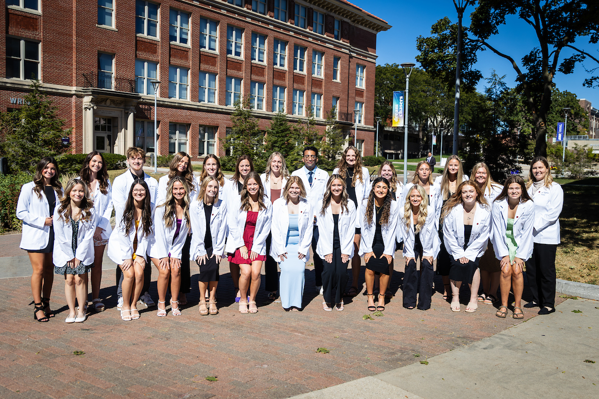 First cohort of UNI's standalone BSN pose in their white coats