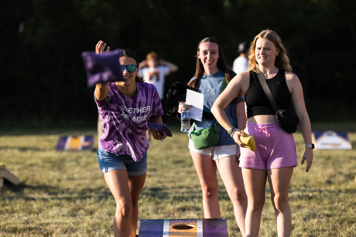 Students playing cornhole on UNI campus