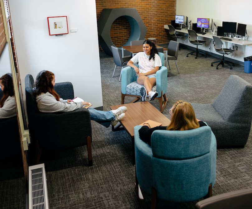 Students chatting in student lounge area of TEACH Studio 