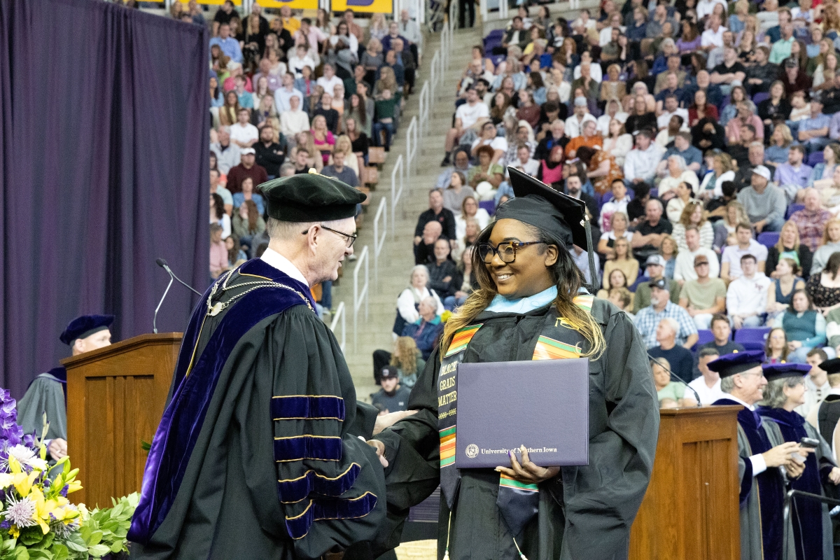 Sheritta Stokes shaking President Nook's hand at Commencement