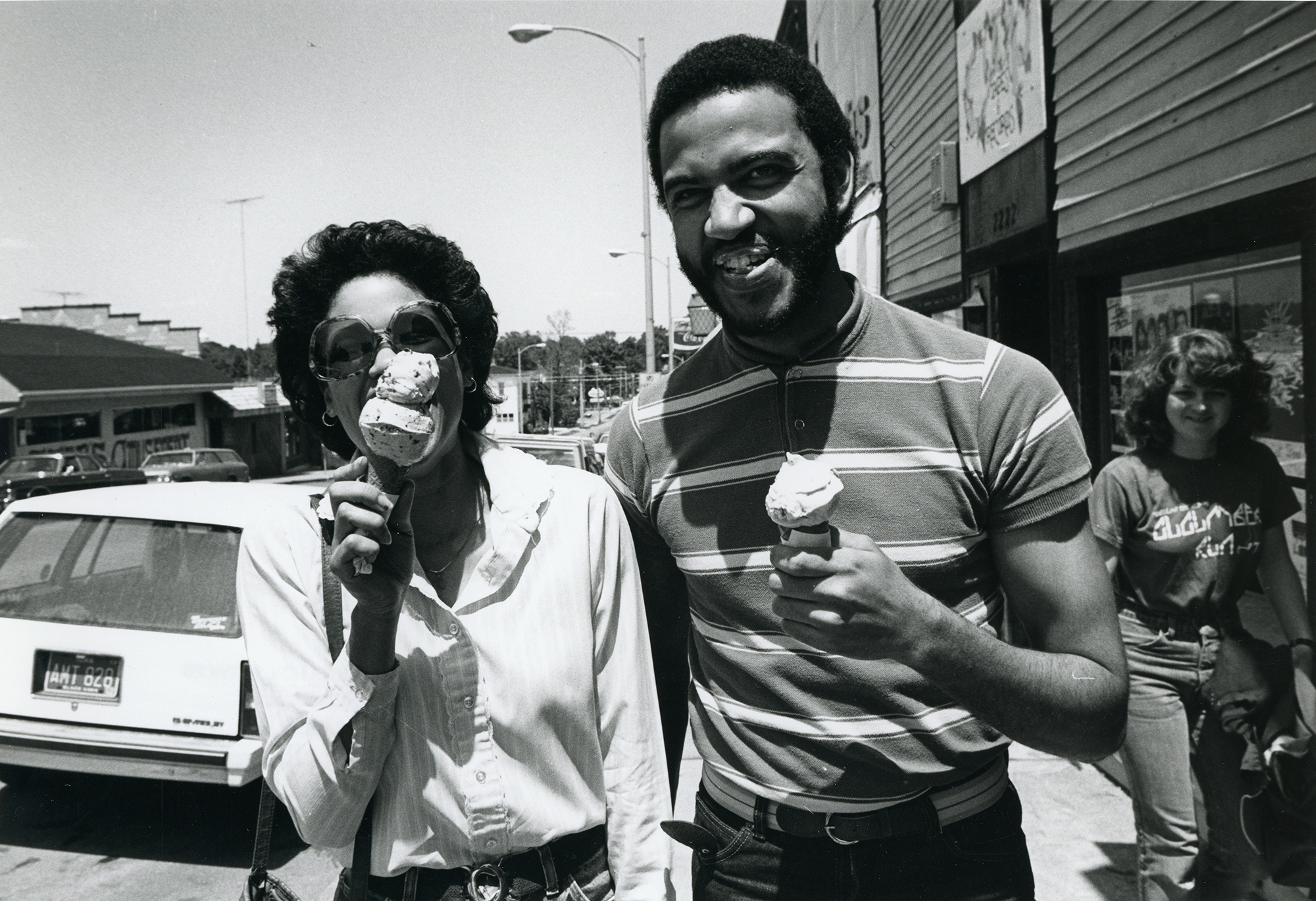 A man and woman enjoy ice cream while walking on College Hill near the UNI campus.