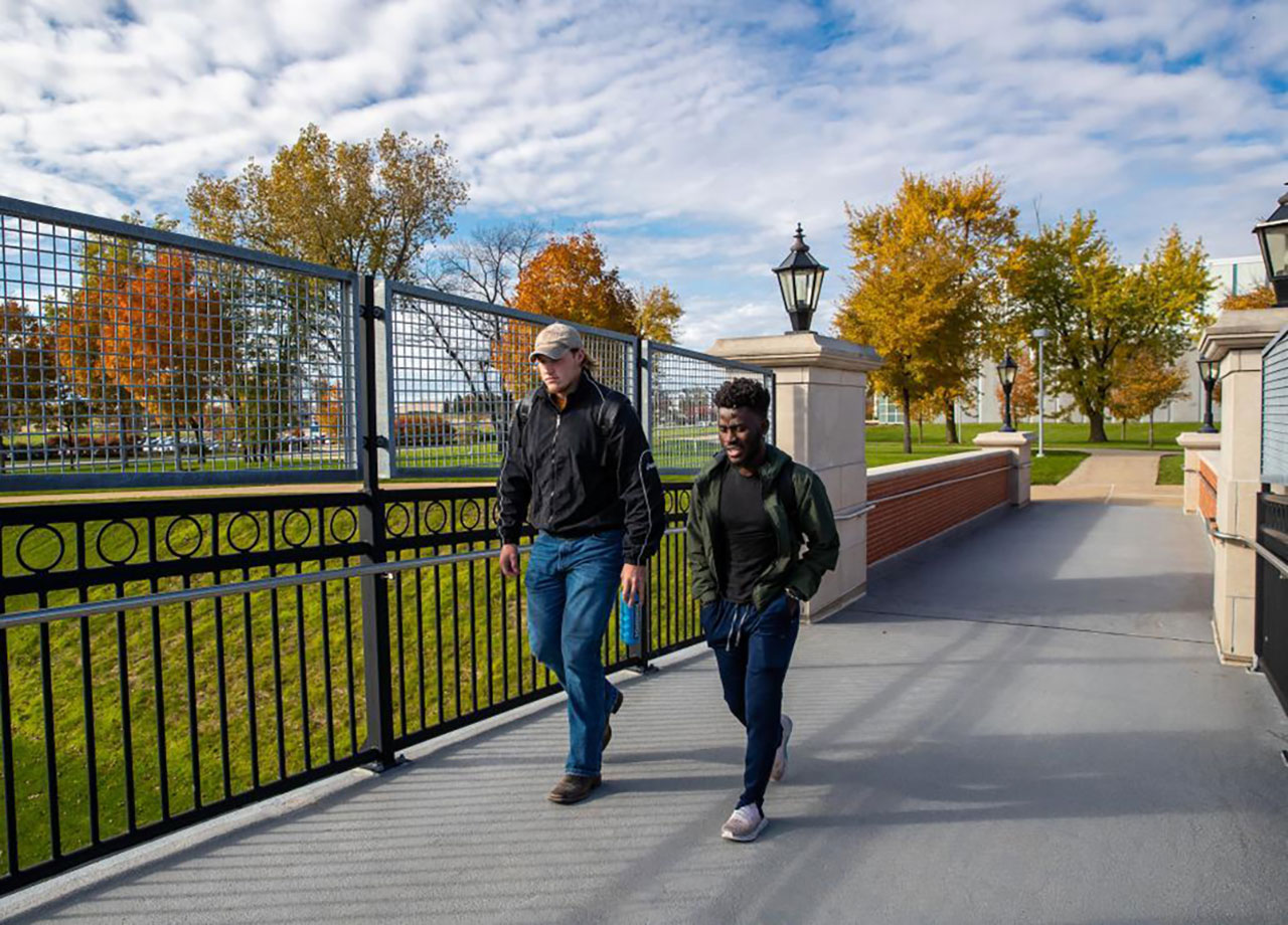 Two students walking on campus.