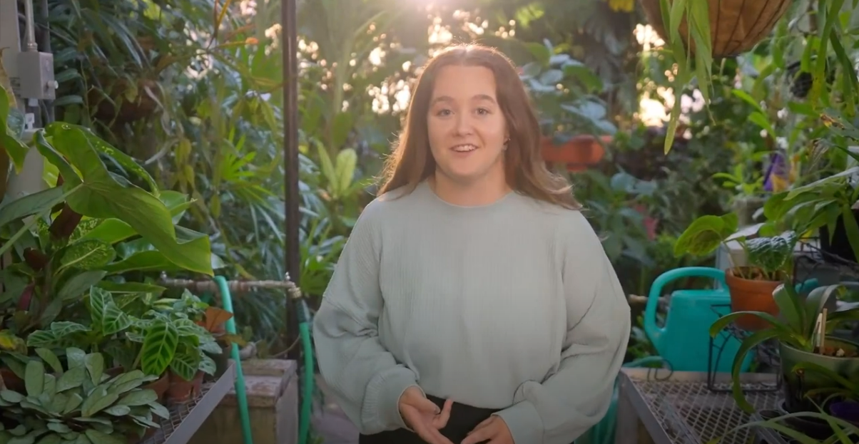 Grace Fleming in the UNI greenhouse