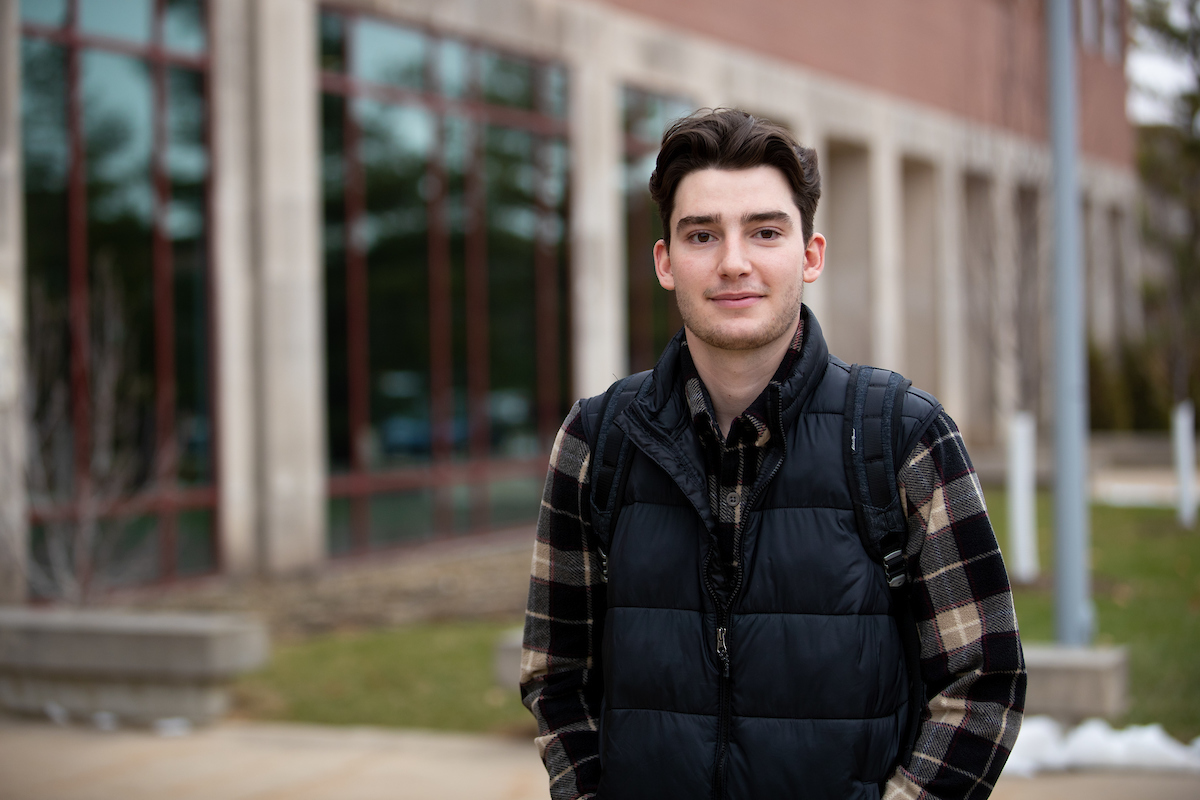 Cole Wilkin in front of Curris Business Building