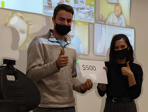 Students holding paper saying "$500"